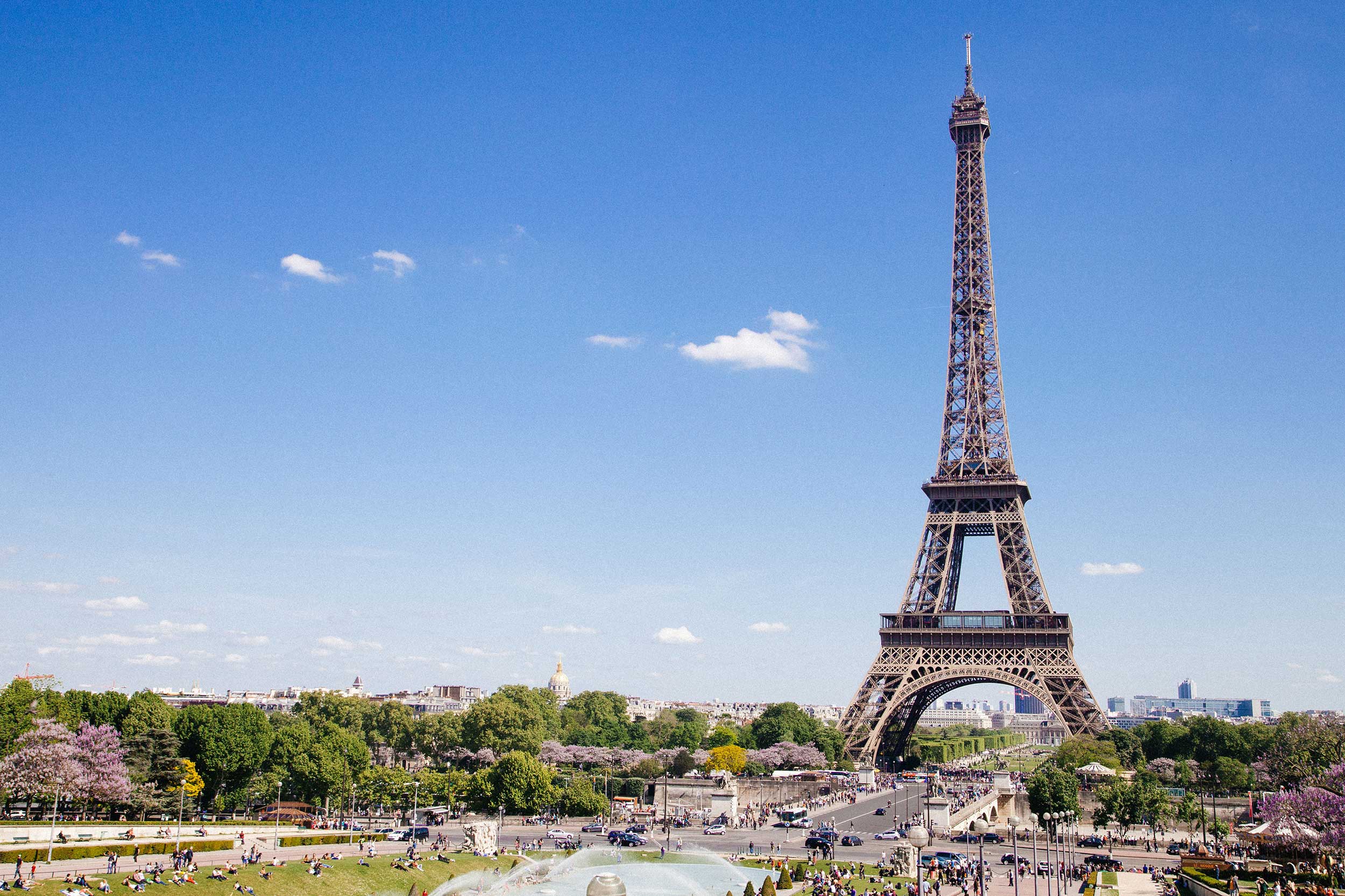 Iconic Eiffel Tower standing tall against a clear blue sky, epitomising the thrill of driving in France for Channel Island residents.