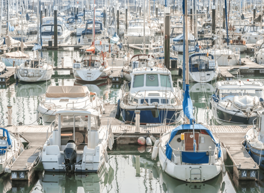 Diverse boats docked in a marina, ready for inspection with the 'Boat Owners Checklist' for safe and prepared sailing in the Channel Islands.